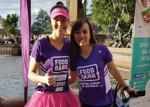 Two woman registers at city2surf 2019 in foodbank team