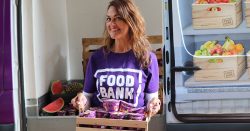 Chrissie wearing a foodbank shirt and smiling