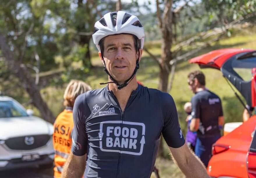 Matt Keenan wearing his Hunger Ride top and a bike helmet