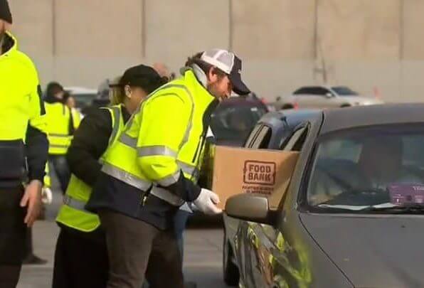 man giving foodbank food box to the car on the Drive Thru event