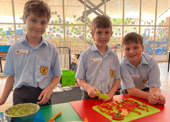 three boys learning how to cook