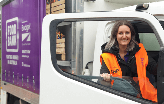 Foodbank Bunbury vehicles with a woman smiling
