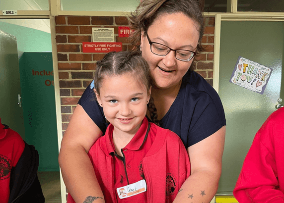 Katie with a child smiling