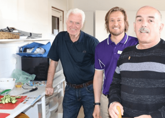 three men smiling at the camera