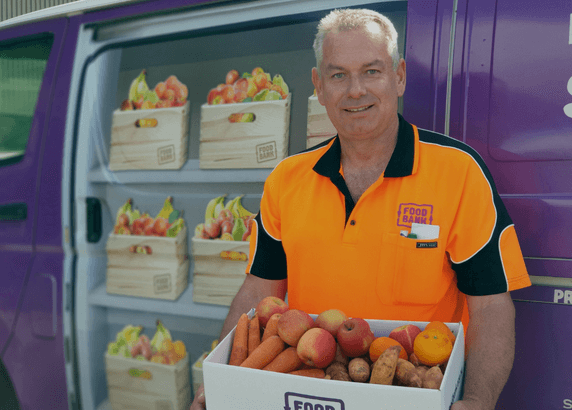 man holding a box of fruits