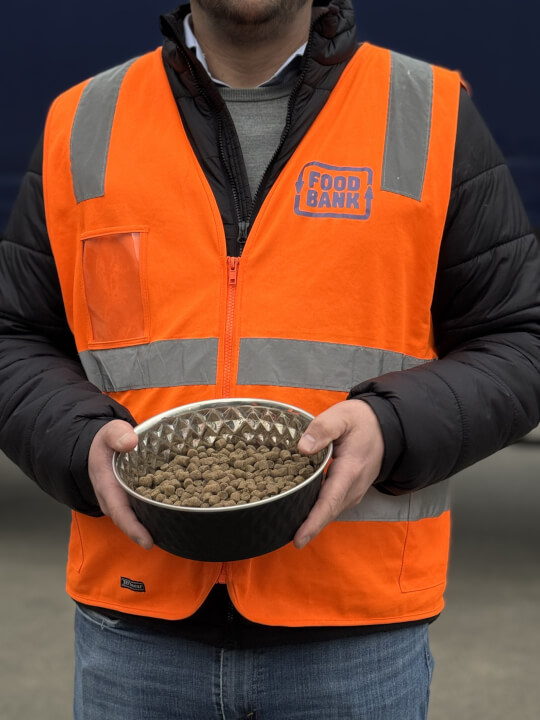 Person from Foodbank holding a bowl of dog food