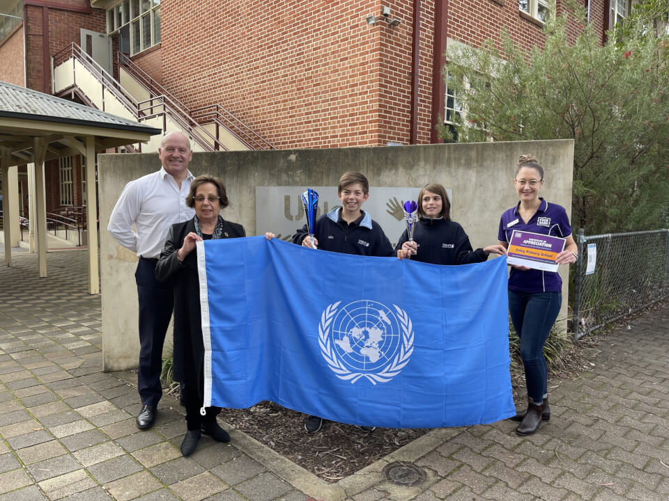 Unley Primary School holding a blue big flag