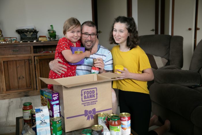 Phillip's family receiving food support from feeding hope hampers